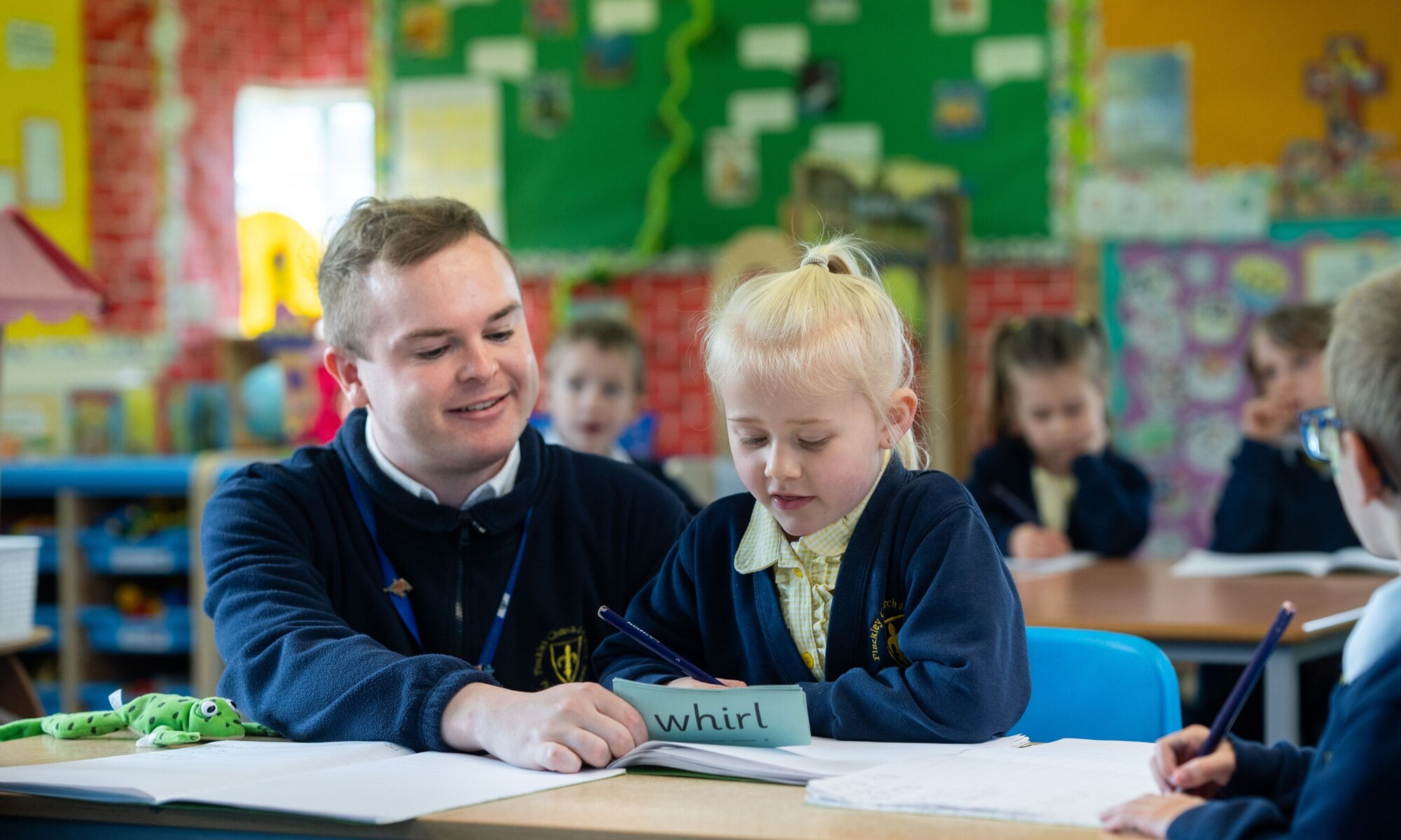Pluckley CE Primary teacher helping pupil with her work